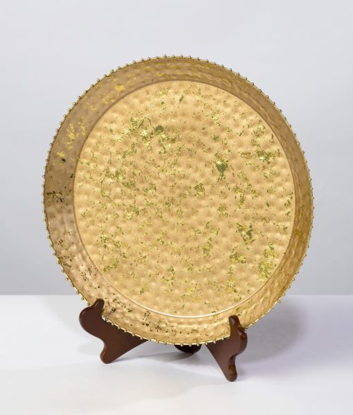 This gold enamel platter with a beaded edge is the essence of fine dinning